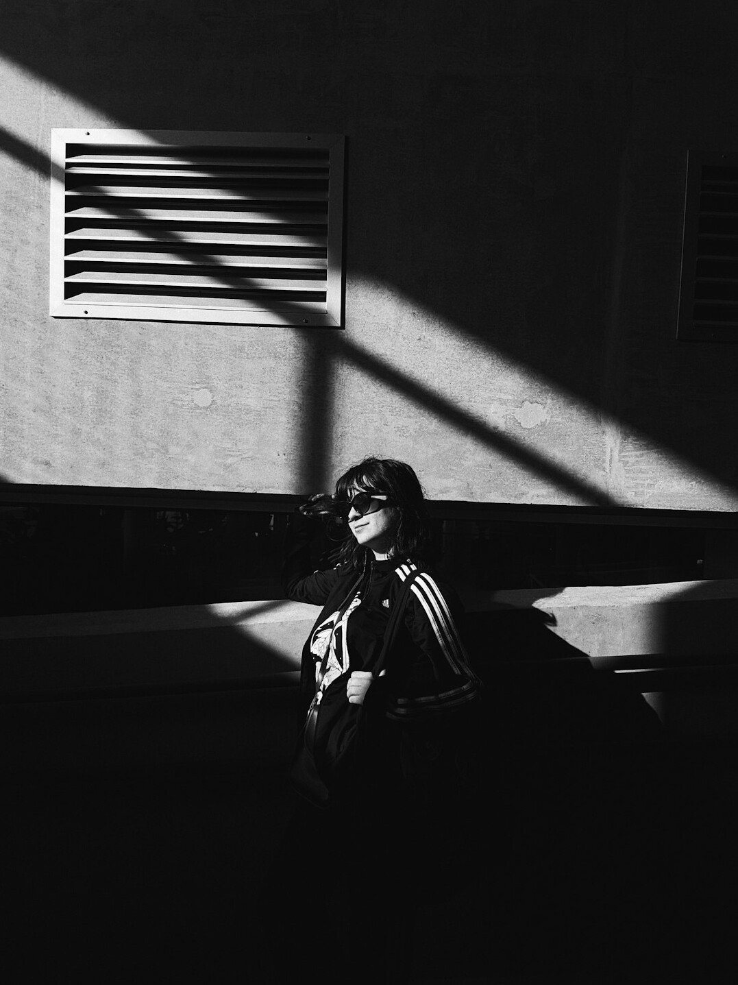 Brazilian woman with glasses reflecting near a window