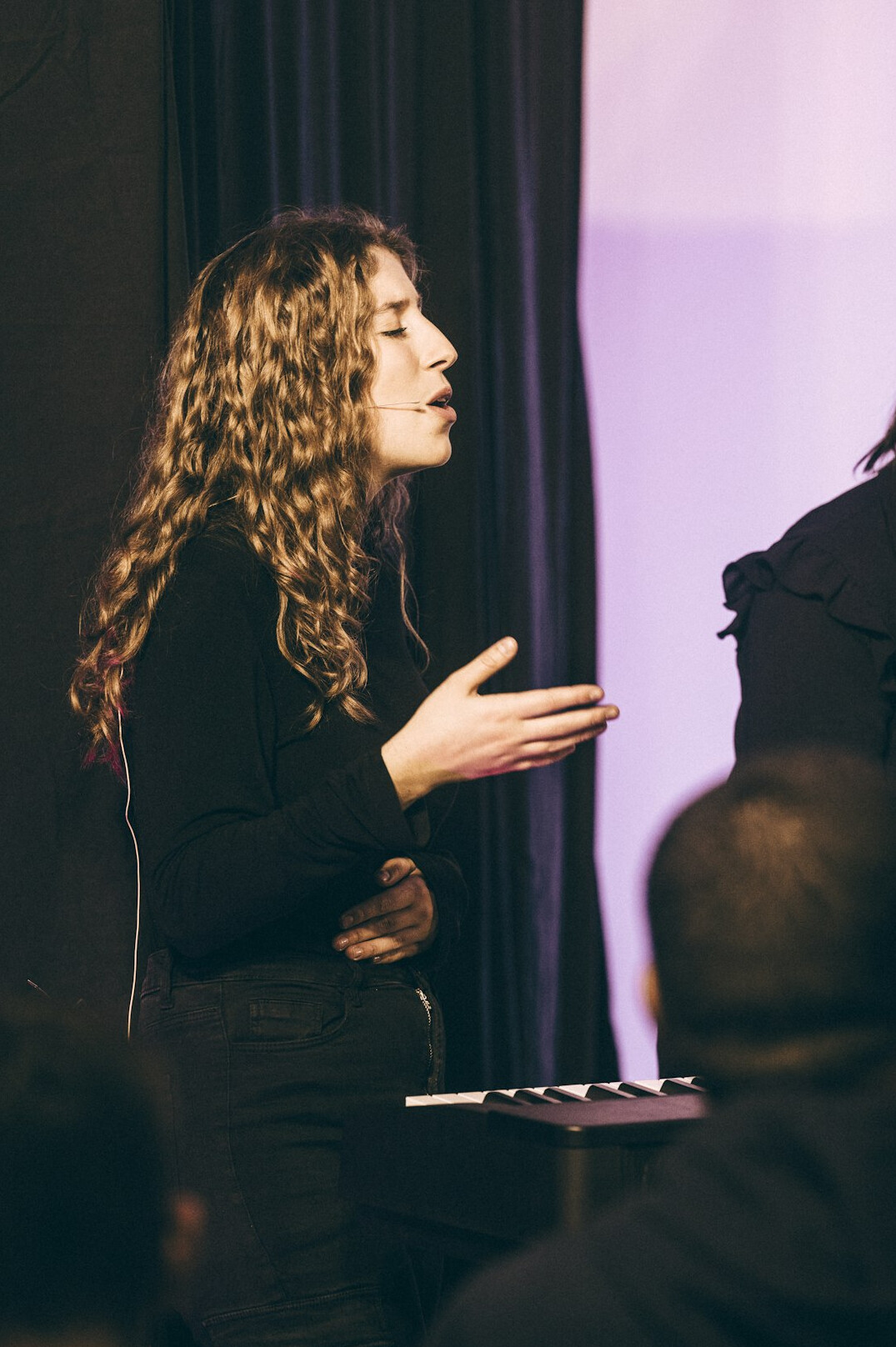 woman giving confident speech on stage