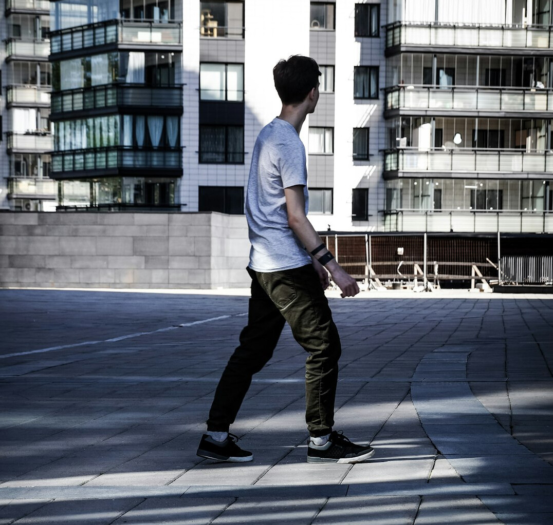 Brazilian man walking and talking in a corridor