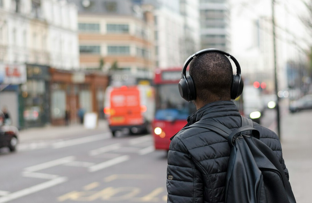 Brazilian man with headphones listening attentively at a desk
