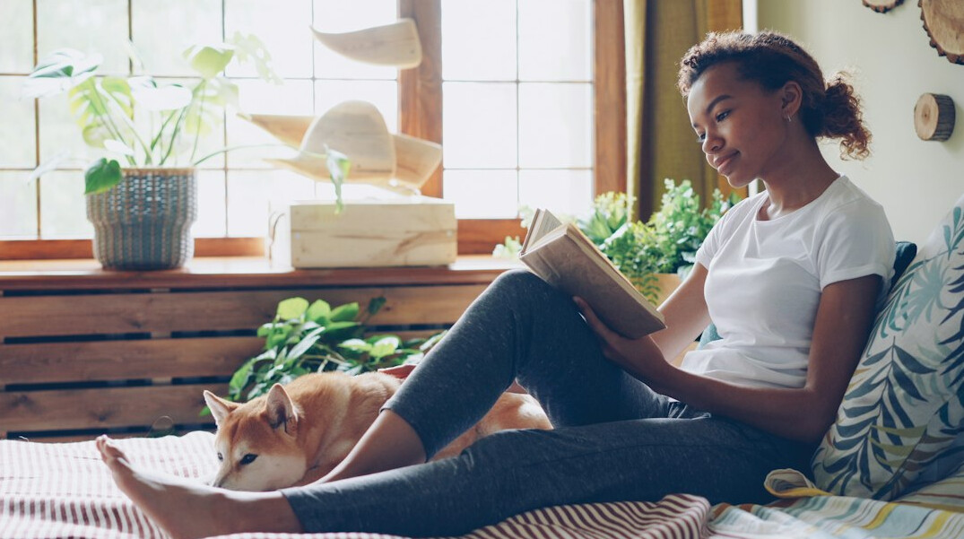 person reading book at home